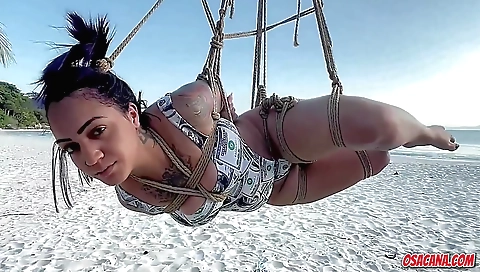 Indian brunette in black outfit masturbates on beach