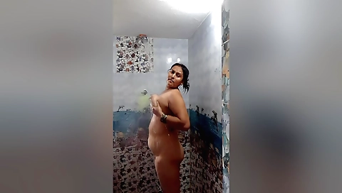 Amateur brunette with big tits enjoys a solo shower