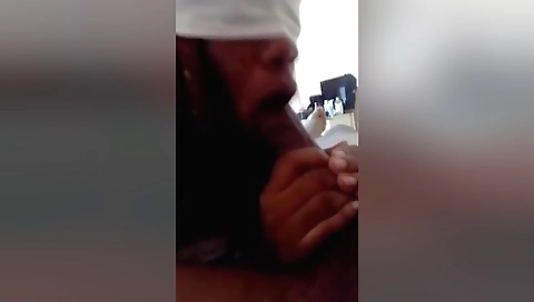 Brunette in a pink top is sitting on a desk by her man