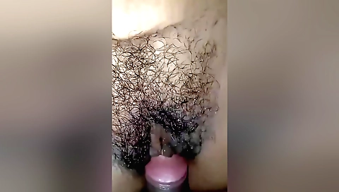 Hairy pussy of a babe covered in oil in a porn scene